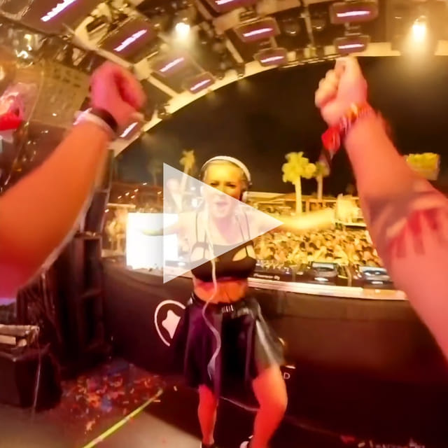 CANDICE dancing in front of the DJ booth with the crowd behind her